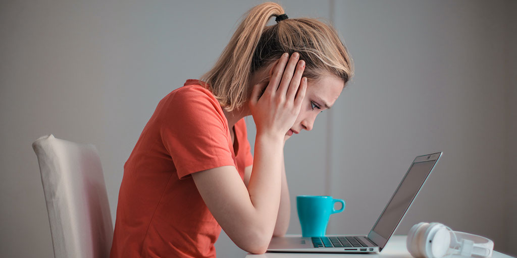 women looking at laptop frustrated at slow website